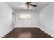 A clean bedroom featuring a ceiling fan, a window and hardwood floors at 4004 W Myrtle Ave, Phoenix, AZ 85051