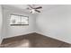 A clean bedroom featuring a ceiling fan, a window and hardwood floors at 4004 W Myrtle Ave, Phoenix, AZ 85051