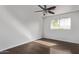 A clean bedroom featuring a ceiling fan, a window and hardwood floors at 4004 W Myrtle Ave, Phoenix, AZ 85051
