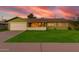 Beautiful one-story home with a lush green lawn, mature landscaping, and an attached two-car garage at 4004 W Myrtle Ave, Phoenix, AZ 85051