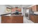 Well-lit kitchen featuring modern appliances, a breakfast bar, and ample counter space at 4004 W Myrtle Ave, Phoenix, AZ 85051