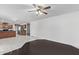 A living room with light walls, stylish flooring, ceiling fan and view of the kitchen at 4004 W Myrtle Ave, Phoenix, AZ 85051