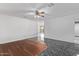 A living room with light walls, stylish flooring and ceiling fan at 4004 W Myrtle Ave, Phoenix, AZ 85051