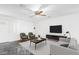 Bright living room featuring neutral furniture, a ceiling fan, and a decorative marbled floor at 4004 W Myrtle Ave, Phoenix, AZ 85051