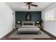 Main bedroom with a decorative panel wall, neutral bedding, and modern nightstands at 4004 W Myrtle Ave, Phoenix, AZ 85051