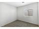 Cozy bedroom featuring carpet, a window with blinds, and neutral paint at 42875 W Vincent Dr, Maricopa, AZ 85138