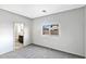 Bright bedroom with neutral carpet, a window, and an ensuite bathroom at 42875 W Vincent Dr, Maricopa, AZ 85138