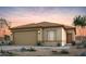 Charming single-story home featuring a two-car garage, desert landscaping, and a neutral color palette at 42875 W Vincent Dr, Maricopa, AZ 85138