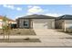 Charming single-story home with a two-car garage and low-maintenance desert landscaping in the front yard at 42875 W Vincent Dr, Maricopa, AZ 85138