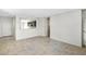 Spacious living room features tile flooring and an open view to the kitchen at 42875 W Vincent Dr, Maricopa, AZ 85138