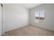 Bright bedroom featuring a window with blinds and carpeted floors at 42900 W Peters Dr, Maricopa, AZ 85138