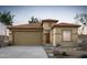 Charming single-story home featuring a two-car garage, a tiled roof, and desert landscaping in a warm, inviting color palette at 42900 W Peters Dr, Maricopa, AZ 85138