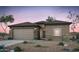 Inviting single-story home featuring a two-car garage and desert landscaping at 42925 W Palo Amarillo Rd, Maricopa, AZ 85138