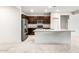 Modern kitchen featuring stainless steel appliances, dark cabinetry, and a large island at 42925 W Palo Amarillo Rd, Maricopa, AZ 85138