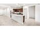Bright kitchen boasts a stainless steel refrigerator, granite counters, and island sink at 42925 W Palo Amarillo Rd, Maricopa, AZ 85138