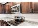 Close up shot of stainless steel microwave and electric cooktop at 42925 W Palo Amarillo Rd, Maricopa, AZ 85138