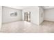 Open living space with tile flooring, a sliding door, and a bright window at 42925 W Palo Amarillo Rd, Maricopa, AZ 85138