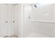 Bright, tiled walk-in shower with sleek fixtures and a built-in bench at 42925 W Palo Amarillo Rd, Maricopa, AZ 85138