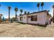 View of a backyard with access to a pool, palm trees, and the side of a white house at 4702 W Northview Ave, Glendale, AZ 85301
