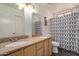 Double sink bathroom with two mirrors and tiled floor, offering a clean and functional space at 4702 W Northview Ave, Glendale, AZ 85301