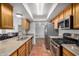 Bright kitchen boasts stainless steel appliances, granite countertops, and ceramic tile flooring at 4702 W Northview Ave, Glendale, AZ 85301