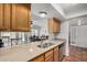 Bright kitchen with granite countertops, stainless steel sink, and view into the dining and Gathering rooms at 4702 W Northview Ave, Glendale, AZ 85301