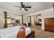 Large primary bedroom featuring sliding glass door access to the Arizona Room and mirrored closet doors at 4702 W Northview Ave, Glendale, AZ 85301