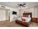 Comfortable main bedroom features fresh paint, a ceiling fan, and a private ensuite bathroom at 4702 W Northview Ave, Glendale, AZ 85301