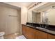 Bathroom featuring a double sink vanity with black granite and a shower at 4808 N 24Th St # 204, Phoenix, AZ 85016
