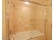 Bathroom featuring a bathtub with a glass door and tile surround at 4808 N 24Th St # 204, Phoenix, AZ 85016
