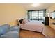 Comfortable bedroom with balcony access, a large bed, and black entertainment center at 4808 N 24Th St # 204, Phoenix, AZ 85016