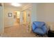 Cozy bedroom showcases a blue chair, mirrored closet doors, and neutral carpet at 4808 N 24Th St # 204, Phoenix, AZ 85016