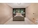 Comfortable bedroom featuring a tufted headboard bed and large window overlooking the lush community at 4808 N 24Th St # 204, Phoenix, AZ 85016
