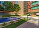 Beautiful courtyard with a serene water fountain, seating, and lush landscaping amidst modern architecture at 4808 N 24Th St # 204, Phoenix, AZ 85016