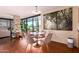 Elegant dining area featuring a round table with pink velvet chairs, a light fixture, and a painting at 4808 N 24Th St # 204, Phoenix, AZ 85016