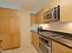 Well-lit kitchen includes stainless appliances, ample cabinetry, and black countertops at 4808 N 24Th St # 204, Phoenix, AZ 85016