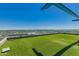 Rooftop deck with artificial turf and glass railings providing unobstructed city views at 4808 N 24Th St # 204, Phoenix, AZ 85016