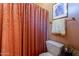 Bathroom featuring patterned peach shower curtain, white toilet, and framed art at 5336 E Gloria Ln, Cave Creek, AZ 85331