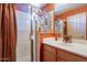 Bathroom with white sink, glass door shower, and orange colored wall at 5336 E Gloria Ln, Cave Creek, AZ 85331