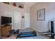 Bright bedroom featuring gym equipment, neutral walls and decor, and sliding door closet at 5336 E Gloria Ln, Cave Creek, AZ 85331