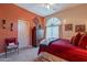 Bedroom featuring red walls, a rounded window and Southwestern decor at 5336 E Gloria Ln, Cave Creek, AZ 85331