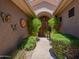 A welcoming covered front entry with lush greenery and decorative art at 5336 E Gloria Ln, Cave Creek, AZ 85331