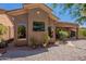 Exterior view showcases large windows and a covered patio, complemented by desert landscaping at 5336 E Gloria Ln, Cave Creek, AZ 85331