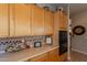 Bright kitchen featuring light wood cabinets, tiled countertops and backsplash, and modern appliances at 5336 E Gloria Ln, Cave Creek, AZ 85331