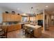 Bright kitchen boasts light wood cabinets, tile countertops, and an island with bar seating at 5336 E Gloria Ln, Cave Creek, AZ 85331