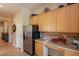 Bright kitchen featuring stainless steel appliances, tile countertops, and light wood cabinets at 5336 E Gloria Ln, Cave Creek, AZ 85331
