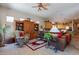 Spacious living room with ceiling fan, view into kitchen, wood furnishings, and area rug at 5336 E Gloria Ln, Cave Creek, AZ 85331