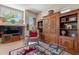 Living room with built-in shelving, fireplace, and large window with greenery view at 5336 E Gloria Ln, Cave Creek, AZ 85331
