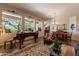 Bright living room with grand piano, comfortable seating, and a view of the outdoors at 5336 E Gloria Ln, Cave Creek, AZ 85331