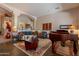 Spacious living room with elegant columns, slate flooring, comfortable seating, and piano at 5336 E Gloria Ln, Cave Creek, AZ 85331